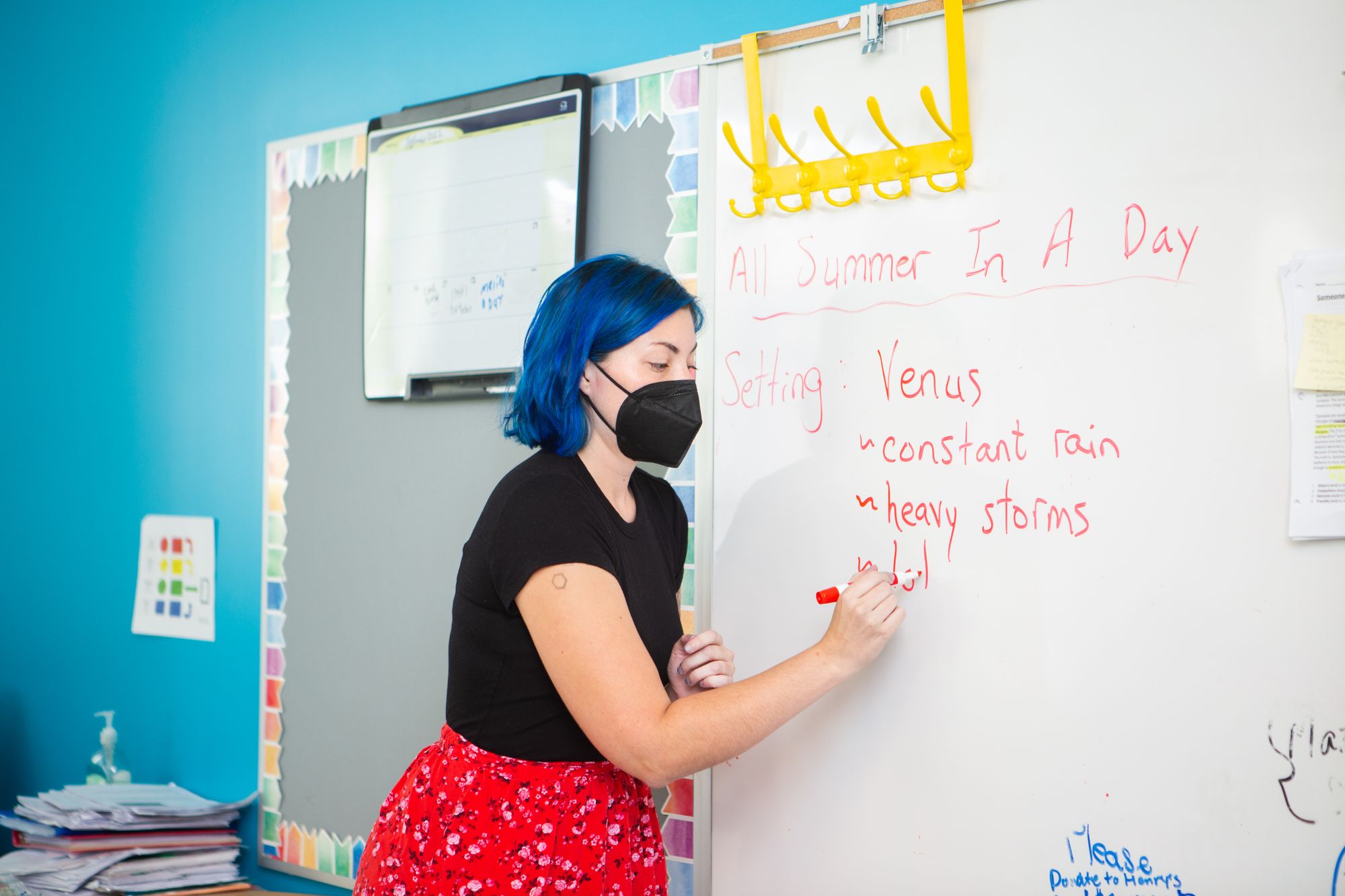 Teacher writing on the board about a CommonLit lesson.